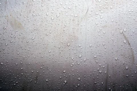 Water droplets gather on a flat surface showing details of size and shape Stock Photos