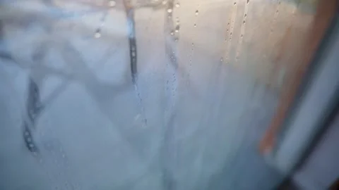 Water droplets on an indoor window during cold winter causing condensation Stock Footage 229762855