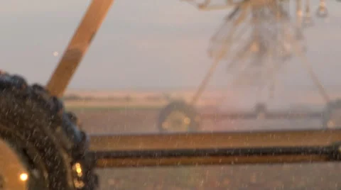 Water droplets from irrigation system sparkle in foreground. Video stock 40032389