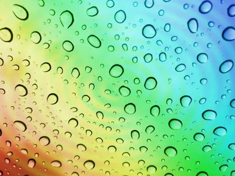 Water droplets on a multicolor surface during heavy rain. Stock Photos