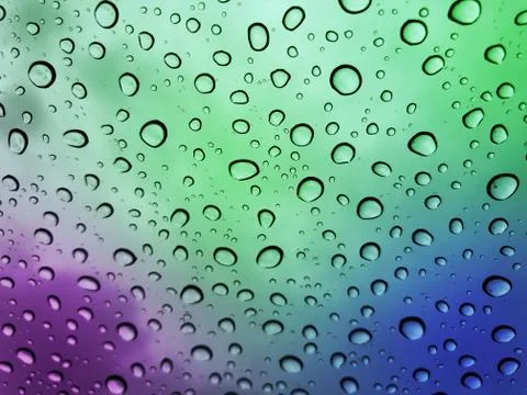 Water droplets on a multicolor surface during heavy rain. Stock Photos