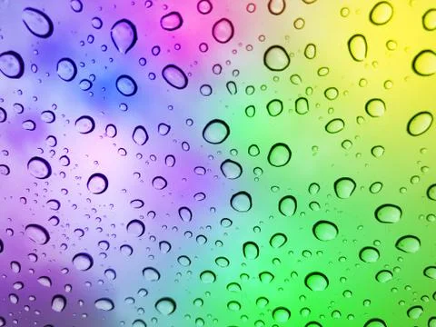 Water droplets on a multicolor surface during heavy rain. Stock Photos