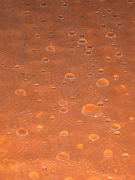 Water Droplets on Orange Table Stock Photos