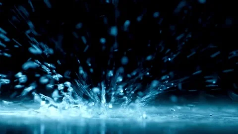 Water droplets splashing on blue surface in slow motion Video stock 332284917