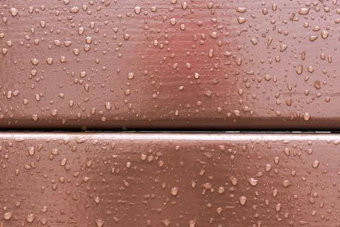 Water droplets on a surface create patterns in the morning light after a rain Stock Photos