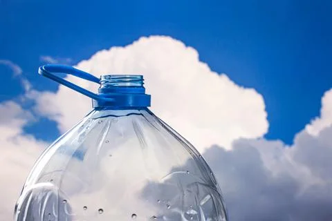 Water droplets on the surface of a transparent plastic bottle with a white cl Stock Photos