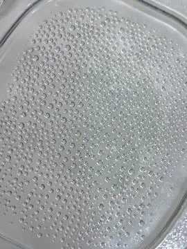 Water droplets on textured surface macro background Stock Photos