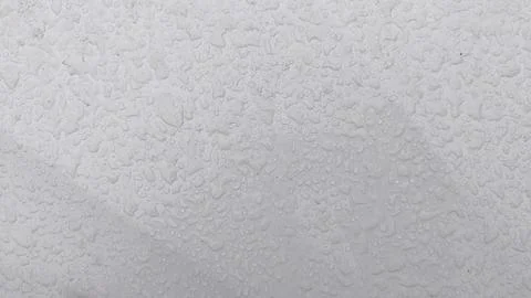 Water droplets on white car surface during rain. Concept of rainy weather Stock Photos