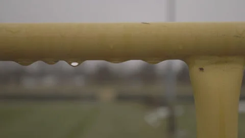 Water Droplets on Yellow Railing Stock Footage 148692464