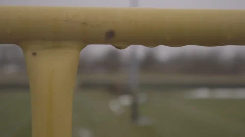 Water Droplets on Yellow Railing Stock Footage 148693403