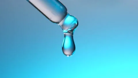 Water dropper in slow motion on blue background Stock Footage 135776989