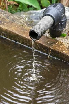 Water dropping in a drinking trough Stock Photos