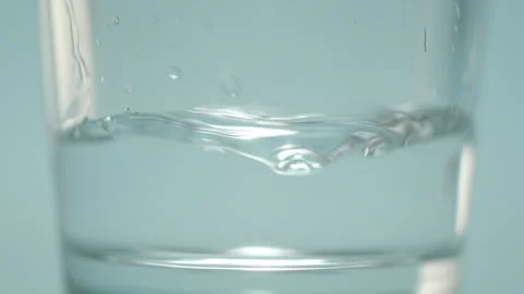 Water dropping into glass 스톡 동영상 240133950