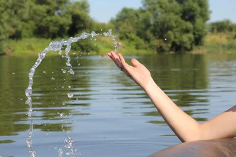 Water dropping from a hand Stock Photos