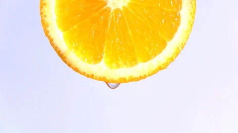 Water dropping on an orange fruit in slow motion. Stock Footage 94390007