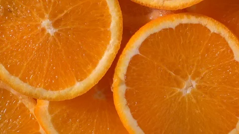 Water dropping on an orange fruit in slow motion. Stock Footage 94393893
