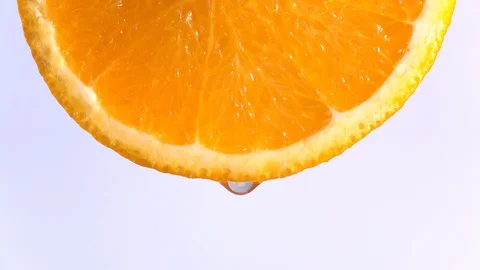 Water dropping on an orange fruit in slow motion. Stock Footage 94512102