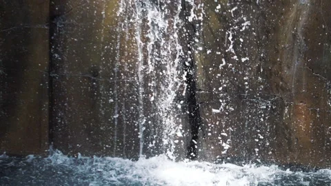 Water dropping through the rocky wall in slow motion 180fps Stockbeeldmateriaal 104313874