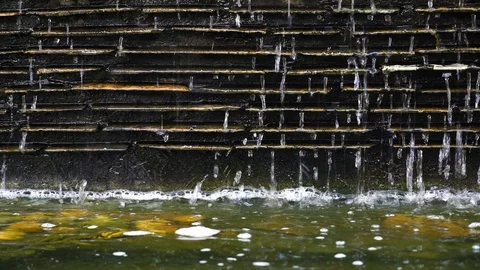 Water dropping on vertical black thin stone cladding Stock Footage 107754038