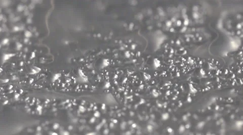 Water dropplets rain down on brushed metal table Stock Footage 55806051