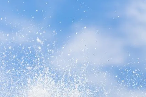 Water drops in the air on the sky. Stock Photos