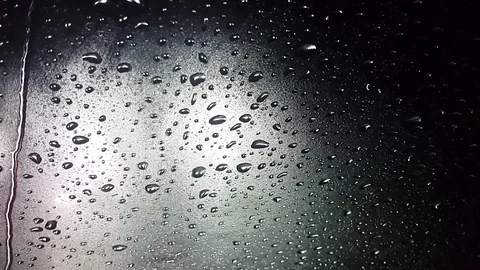 Water drops and rain flows on the windshield glass. Stock Footage 83927205