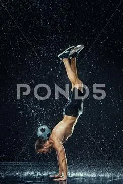 Water drops around football player Stock Photos
