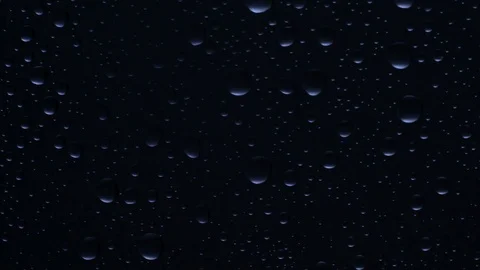 Water drops background. Drops flow down the glass Video stock 75943445