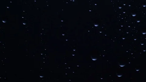 Water drops background. Drops flow down the glass Stock Footage 75943660