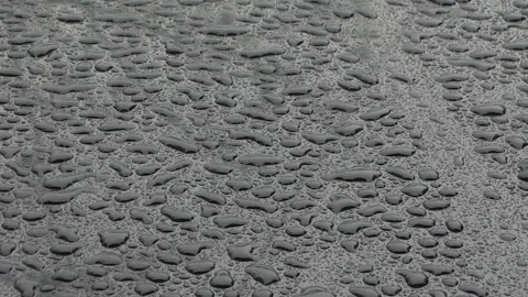 Water drops on black car Stock Footage