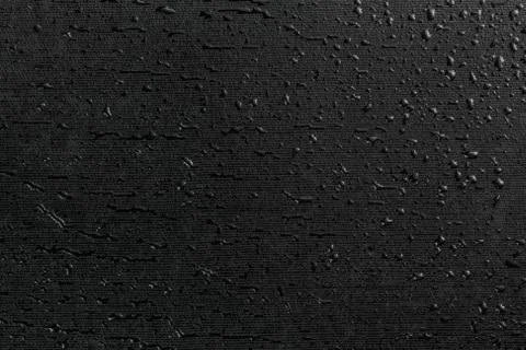 Water drops on black flat rubber surface macro background Photos