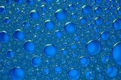 Water drops on blue background Stock Photos