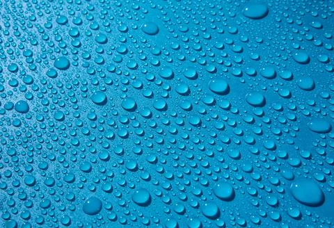 Water drops on blue background Stock Photos