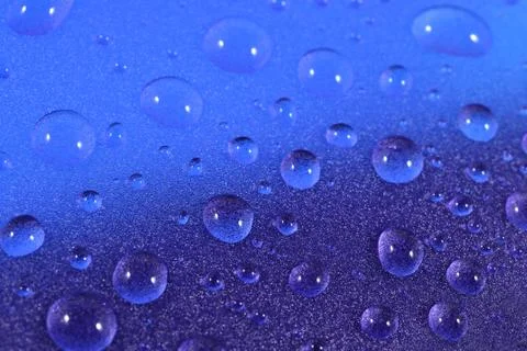 Water drops on blue background. Selective focus. Stock Photos