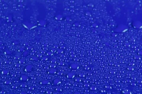 Water drops on blue Stock Photos