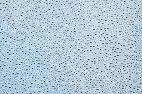 Water drops on blue surface Stock Photos