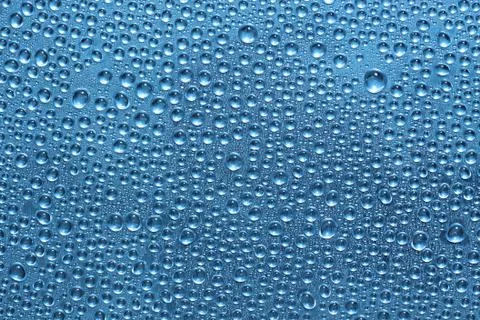 Water drops on blue surface Stock Photos