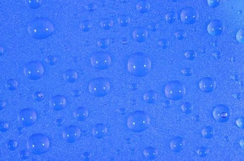 Water drops on the blue surface Stock Photos