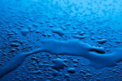 Water drops on blue surface Stock Photos