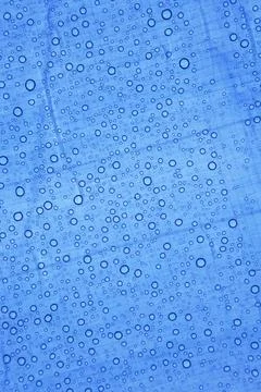 Water drops on blue surface. Stock Photos