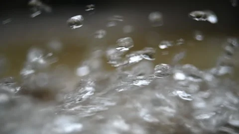 Water drops bounce from a mountain river (slow motion) Video stock 212753894