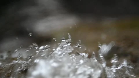 Water drops bounce from a mountain river (slow motion, bokeh) Stock-Footage 212753911