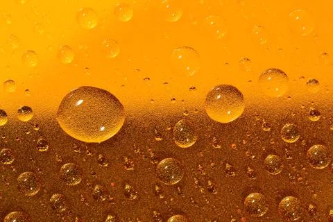 Water drops on the brown surface. Selective focus. Stock Photos