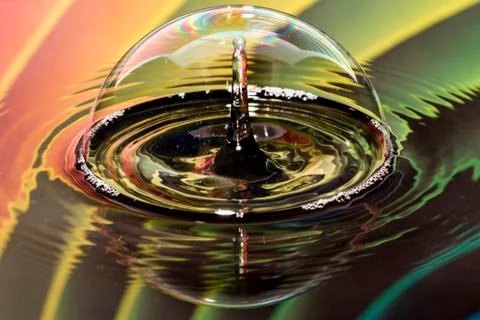 Water drops on bubble with rainbow background Stock Photos
