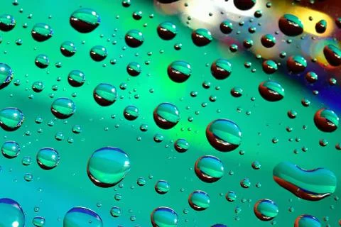 Water drops on colored background Stock Photos
