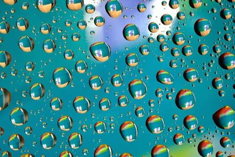 Water drops on colored background Stock Photos