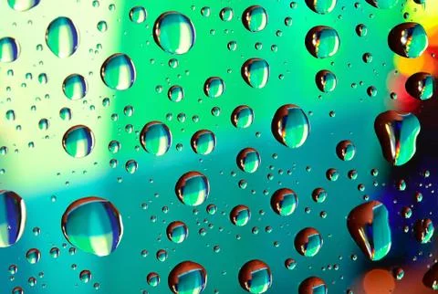 Water drops on colored background Stock Photos