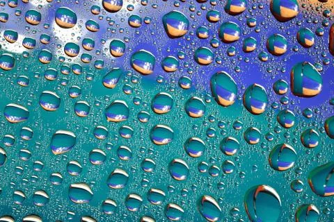 Water drops on colored background Stock Photos