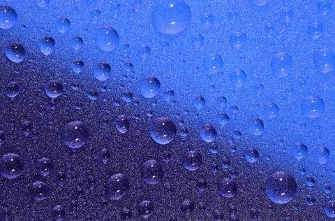 Water drops on colored background. Selective focus. Stock Photos