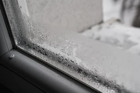 Water drops condensed at cold window during winter season, closeup detail Fotos de archivo